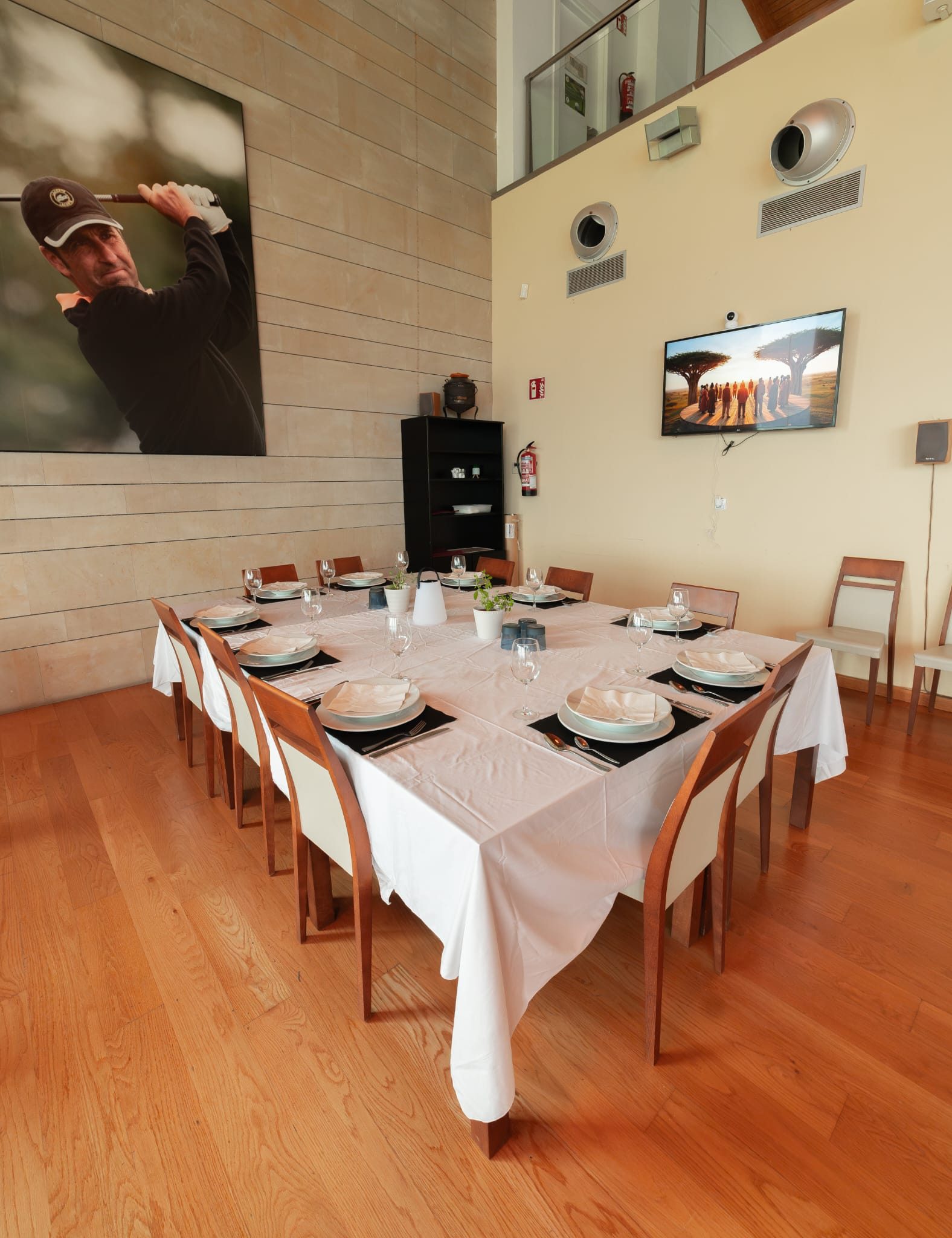 Mesa larga vestida con mantel blanco, montada para una celebración